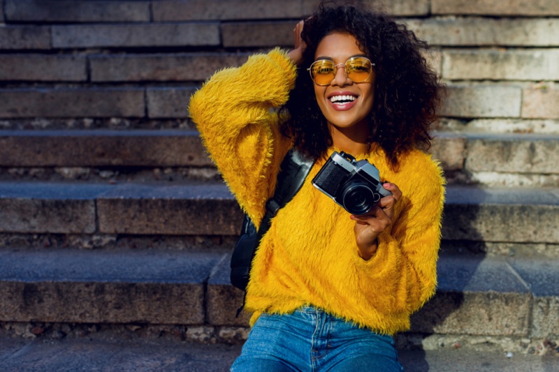 Black Woman Yellow Sweater Jeans Camera