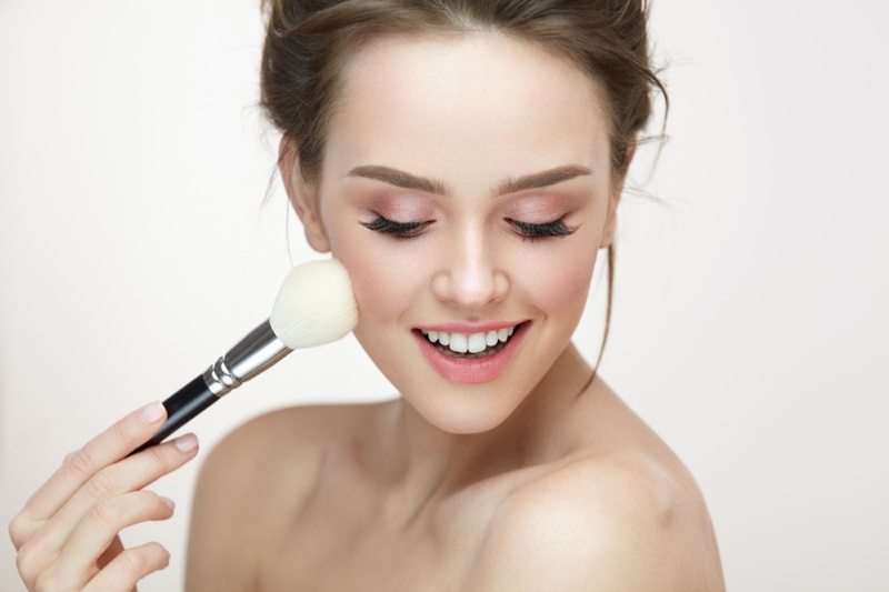 Model Applying Makeup Brush Beauty