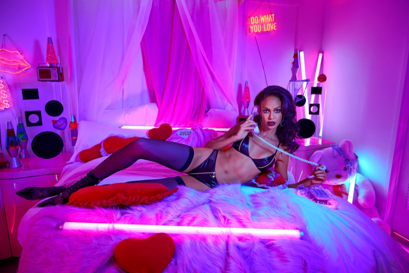 Model Joan Smalls lays in bed for Savage x Fenty x Adam Selman campaign