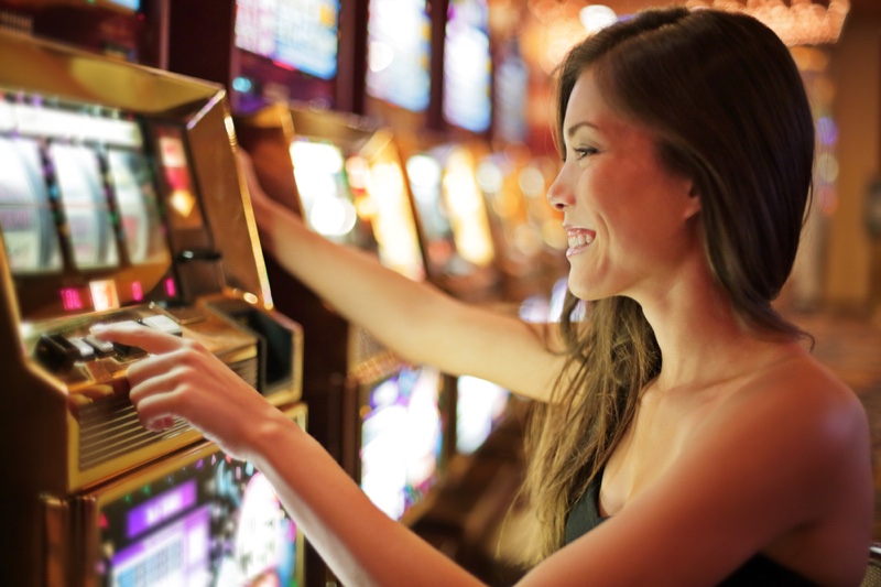 Smiling Asian Young Woman Playing Slots