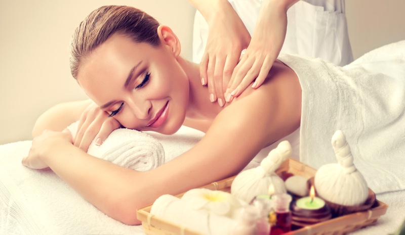 Smiling Blonde Woman Massage Candles