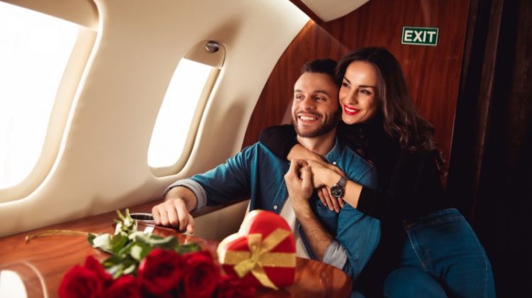 How to Plan Valentine’s Day Surprise for Him in Dubai? Smiling Couple Plane Roses Heart-Shaped Box
