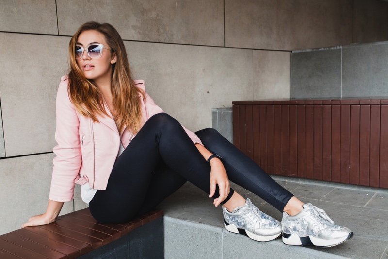 Stylish Woman Leather Pink Jacket Leggings Silver Sneakers Sunglasses