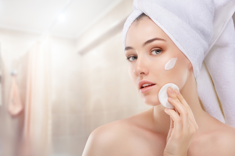 Woman Applying Face Cream Cotton Round Towel