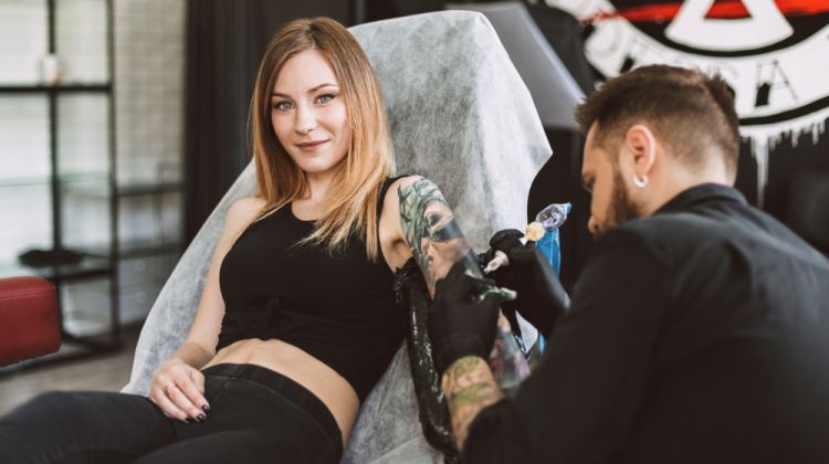 How to Take Care of a New Tattoo in the Winter Woman Getting Tattoo