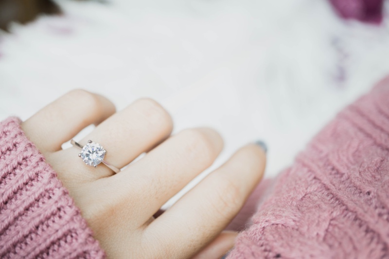 Woman Pink Sweater Diamond Engagement Ring Hand