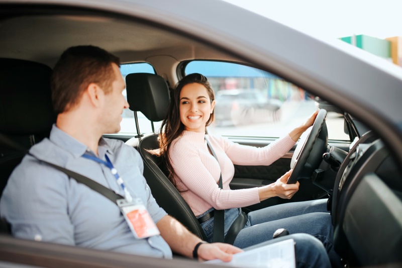 Woman Smiling Driving Instructor Student Man