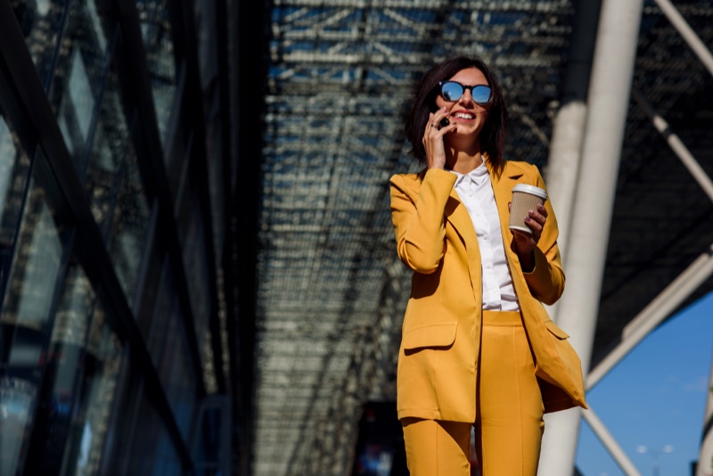 Woman Wearing Yellow Suit Smiling Phone Sunglasses