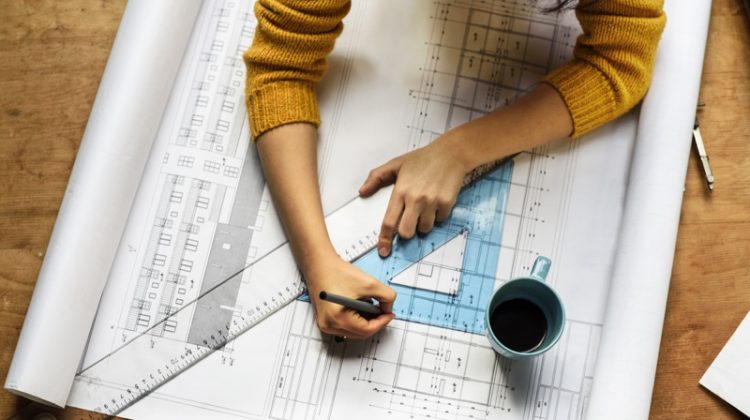 The Need for Revolutionary Architectural Design Architecture Plan Ruler Woman's Hands