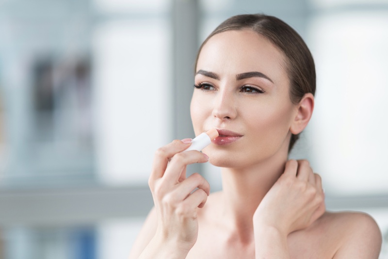 Attractive Woman Applying Lip Balm Stick Beauty