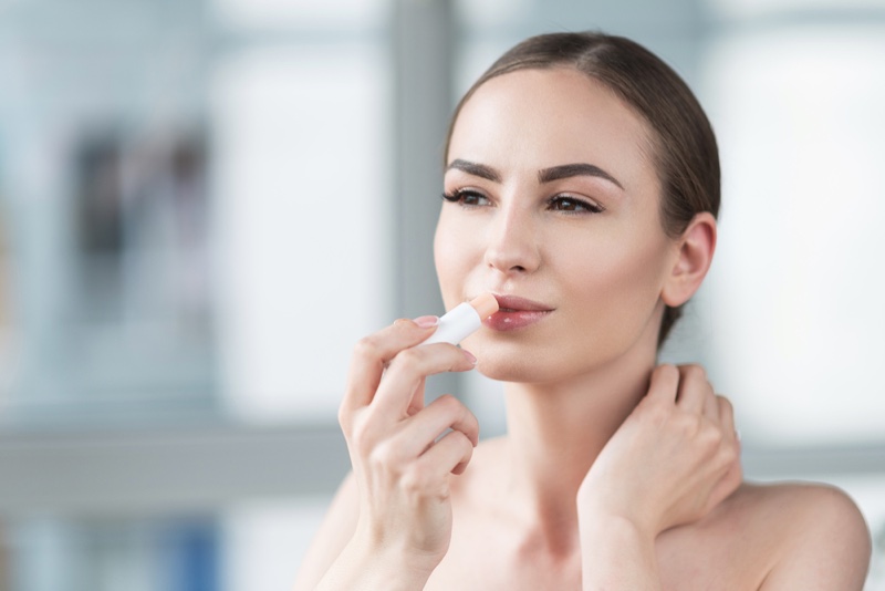 Attractive Woman Applying Lip Balm Stick Beauty