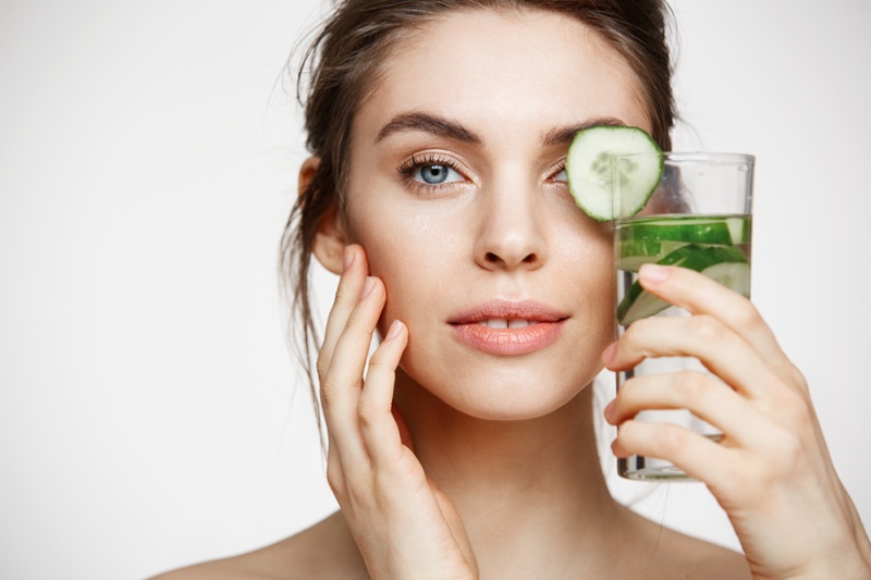 Beauty Model Holding Cucumber Water