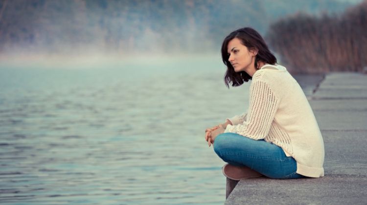 Myths About Addiction Treatment - Avoid Excuses and Seek Help Brunette Woman Sitting Lake Water Sweater Jeans