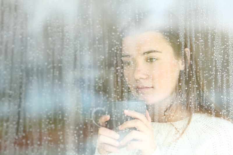 Sad Young Woman Raining Window Cup