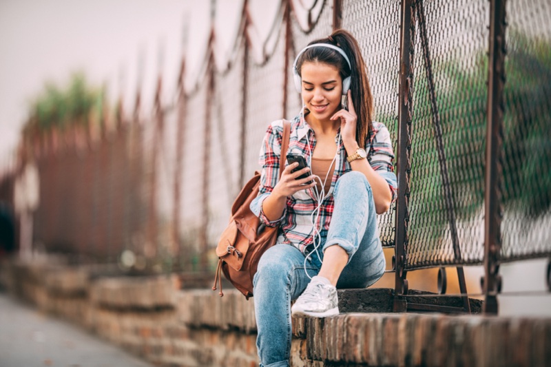 Woman Casual Outfit Backpack Plaid Shirt Jeans Sneakers Headphones