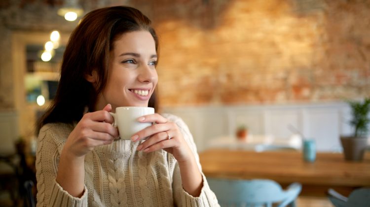 Woman Smiling with Cup of Coffee