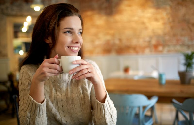 Woman Smiling with Cup of Coffee