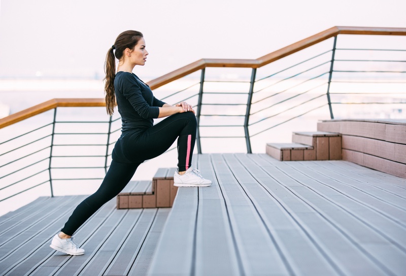 Young Athletic Woman Stretching Before Workout