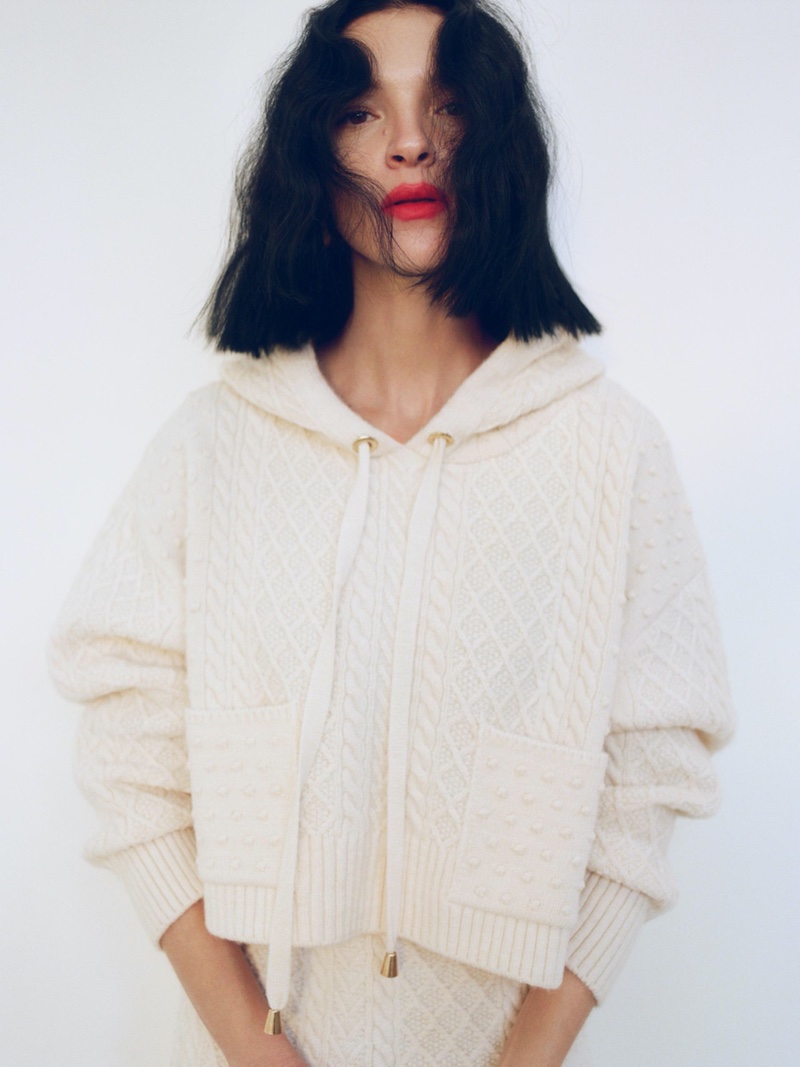 Mariacarla Boscono wears Zara cable-knit sweatshirt and cable knit skirt