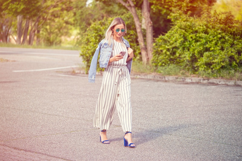 Blonde Woman Wearing Denim Jacket Striped Jumpsuit Sandals