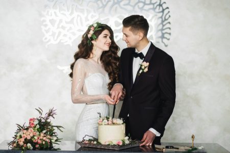 Your Guide to Finding the Perfect Wedding Venue Bride Groom Smiling Wedding Cake Flowers