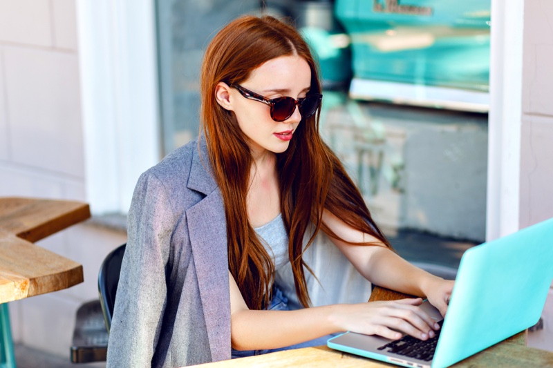 Fashionable Redhead Woman Blue Laptop Sunglasses Blazer