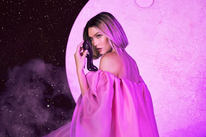 Posing against a moon backdrop, Karlie Kloss appears in Carolina Herrera Good Girl Fantastic Pink fragrance campaign