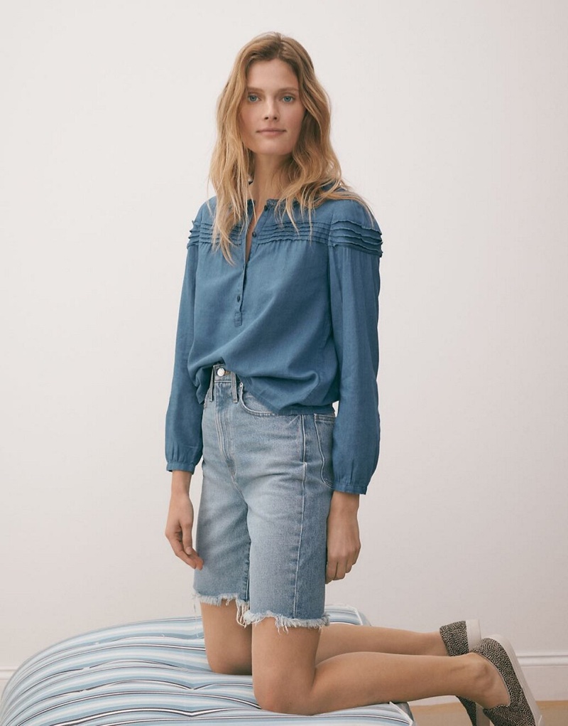 Madewell Indigo Ruffle-Collar Pintuck Popover Top $39.50, High-Rise Long Denim Shorts $74.50 and Sidewalk Slip-On Sneakers in Spotted Calf Hair $98