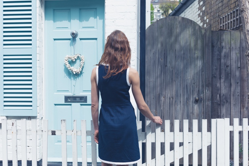 Woman Blue Dress Outside House Blue Door Fence