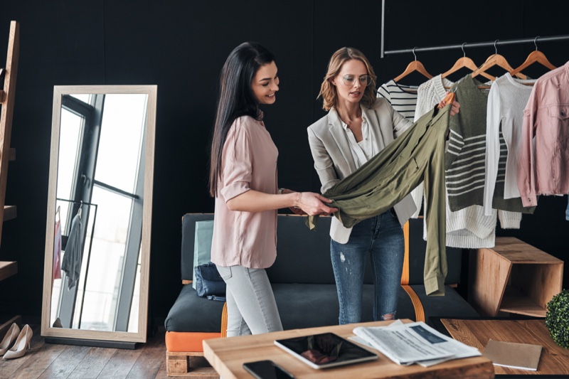 Women Stylist Looking at Clothes Studio