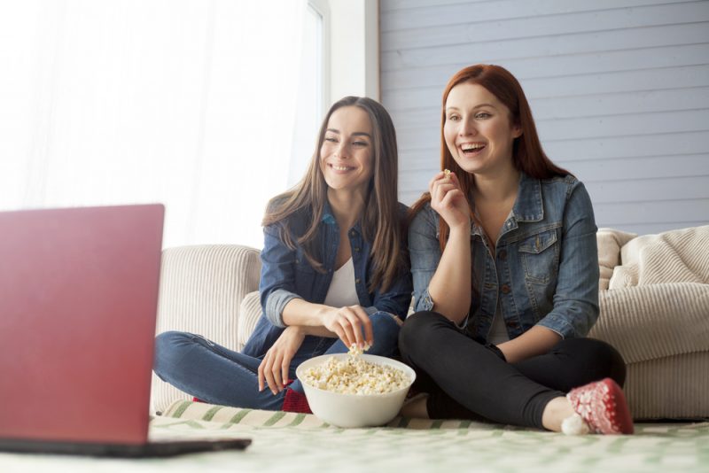 Girlfriends Watching Laptop Eating Popcorn