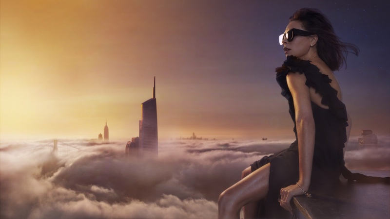 The designer looks over the clouds in Victoria Beckham dress and sunglasses. Photo: An Le