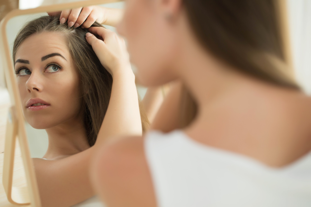 Woman Checking for Thinning Hair