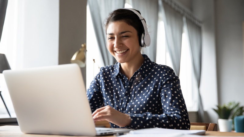 Woman Laptop Smiling Headphones Polka Dot Print Shirt