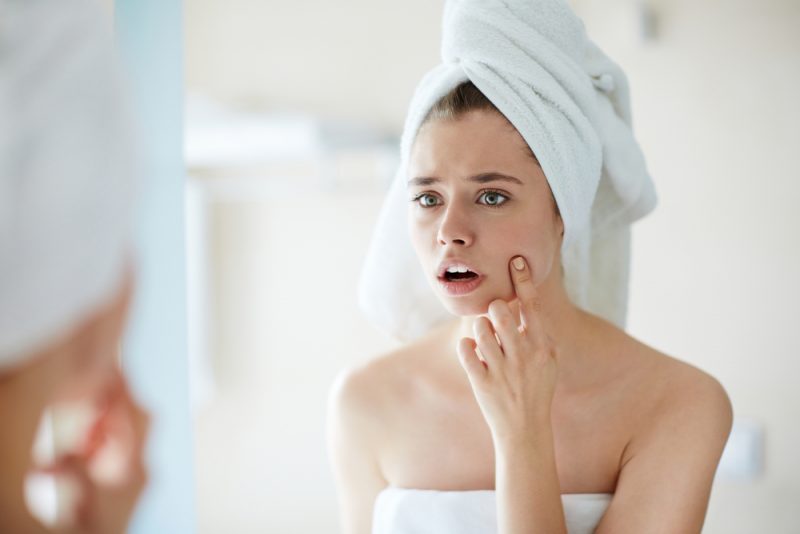 Woman Noticing Pimple