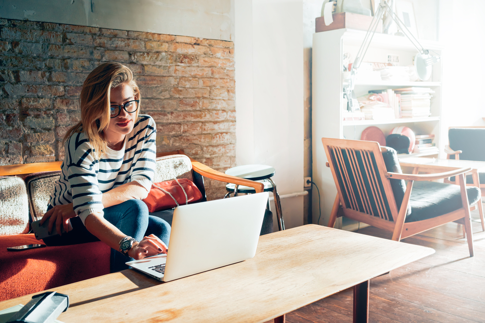 Woman Wearing Glass on Laptop in Living Room