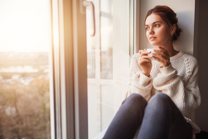 Woman Window Light Cup Sweater Sitting