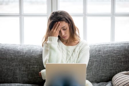 How to Deal With Anxiety in the Pandemic Anxious Woman Laptop Sweater Worried