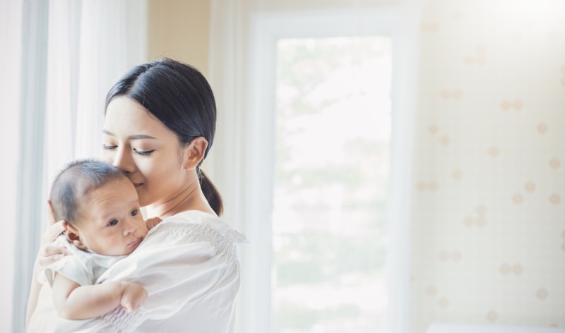 Asian Mother Holding Baby