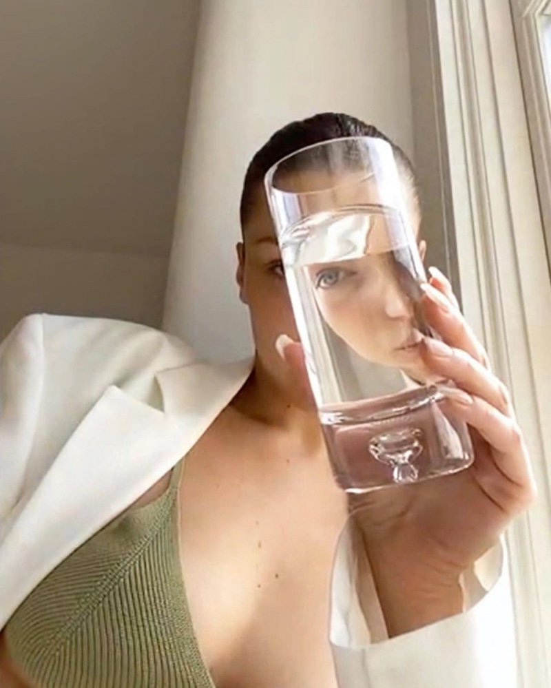 Posing with a glass of water, Bella Hadid fronts Jacquemus spring-summer 2020 digital campaign.