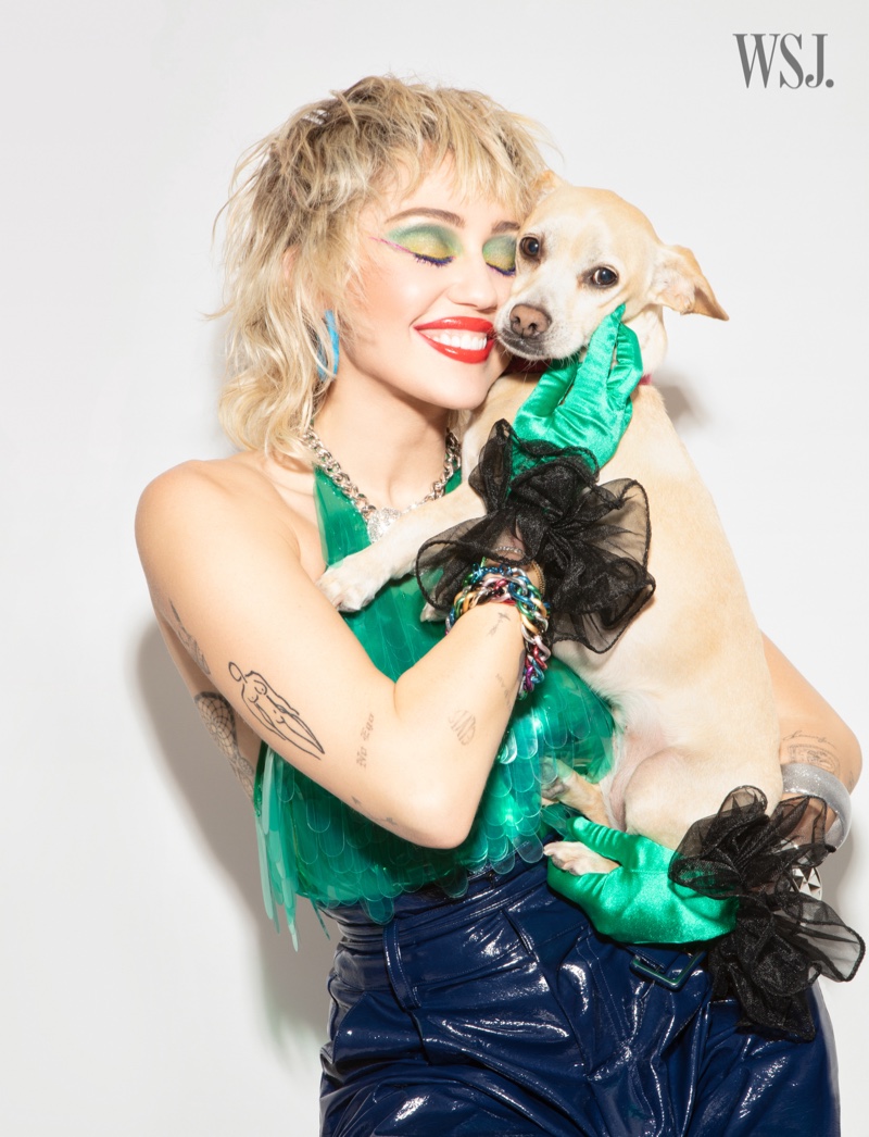 Posing with her dog, Miley Cyrus is all smiles.