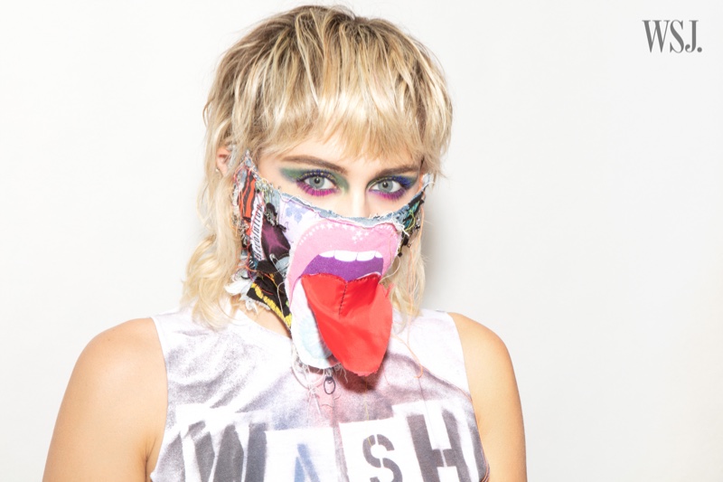 Singer Miley Cyrus poses in a customized face mask.