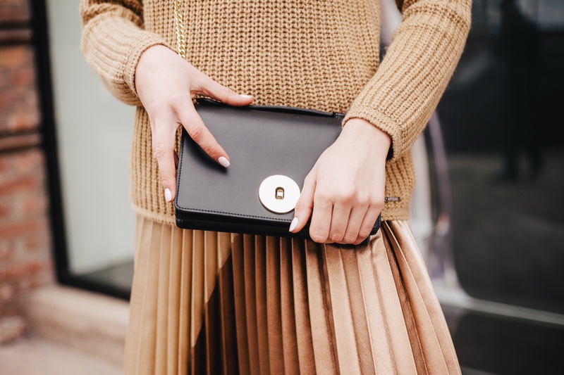 Woman Holding Black Clutch