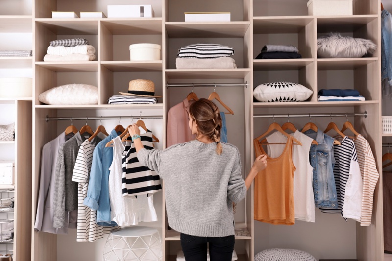 Woman Organizing Closet Clothes Wardrobe