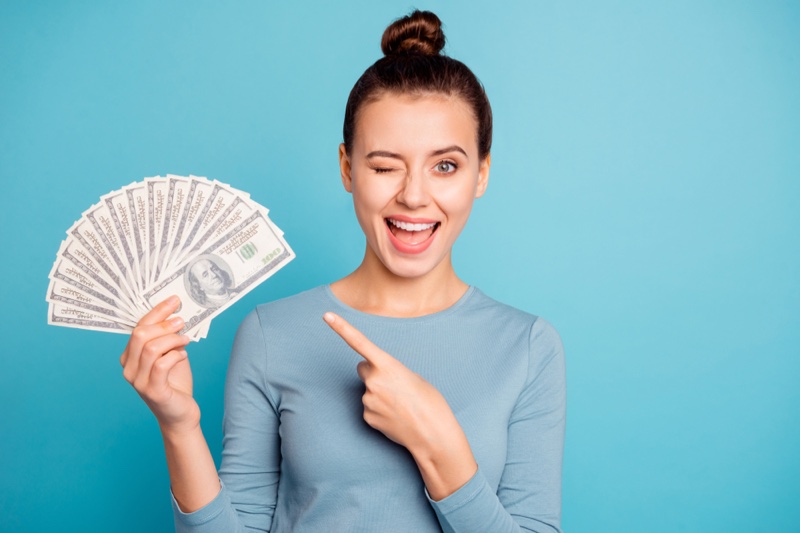 Woman Winking Holding Money Bun