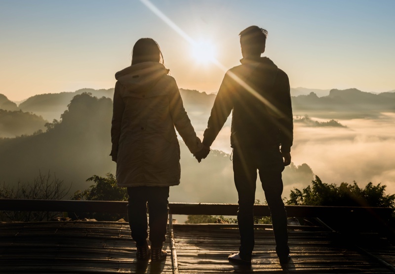 Couple Holding Hands Outside Mountain