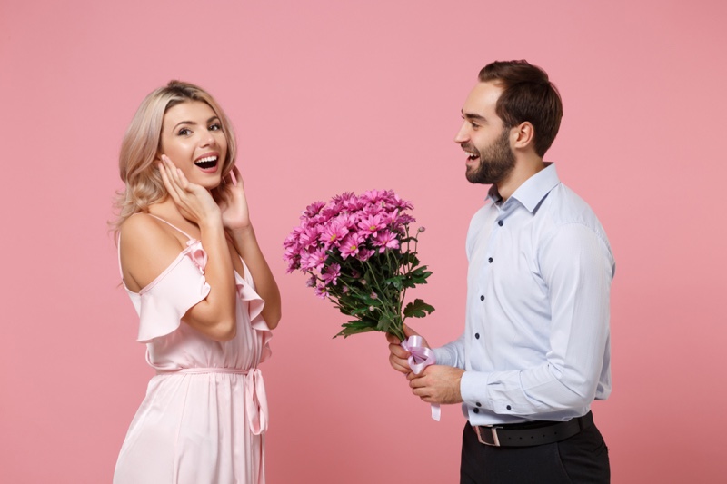 Couple Man Holding Flowers Woman Smiling Pink Dress