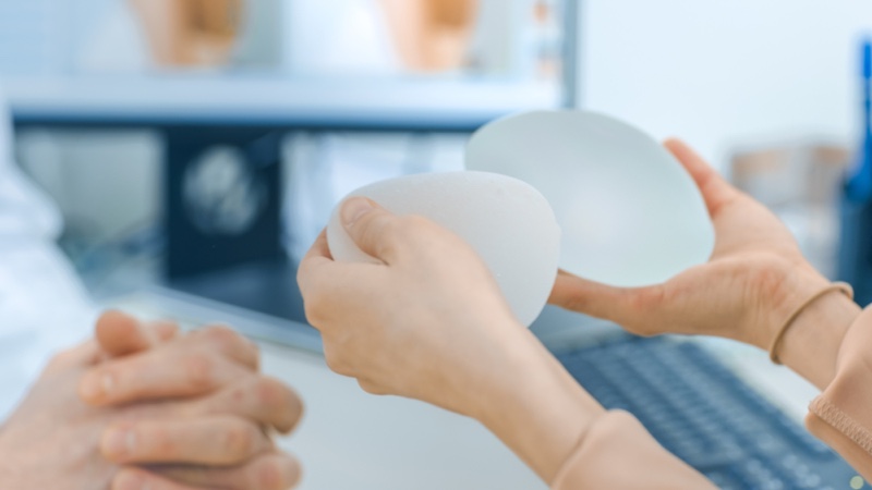 Dr's Office Woman Holding Breast Implants