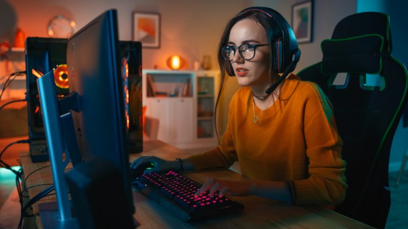 Female Gamer in Orange Sweater