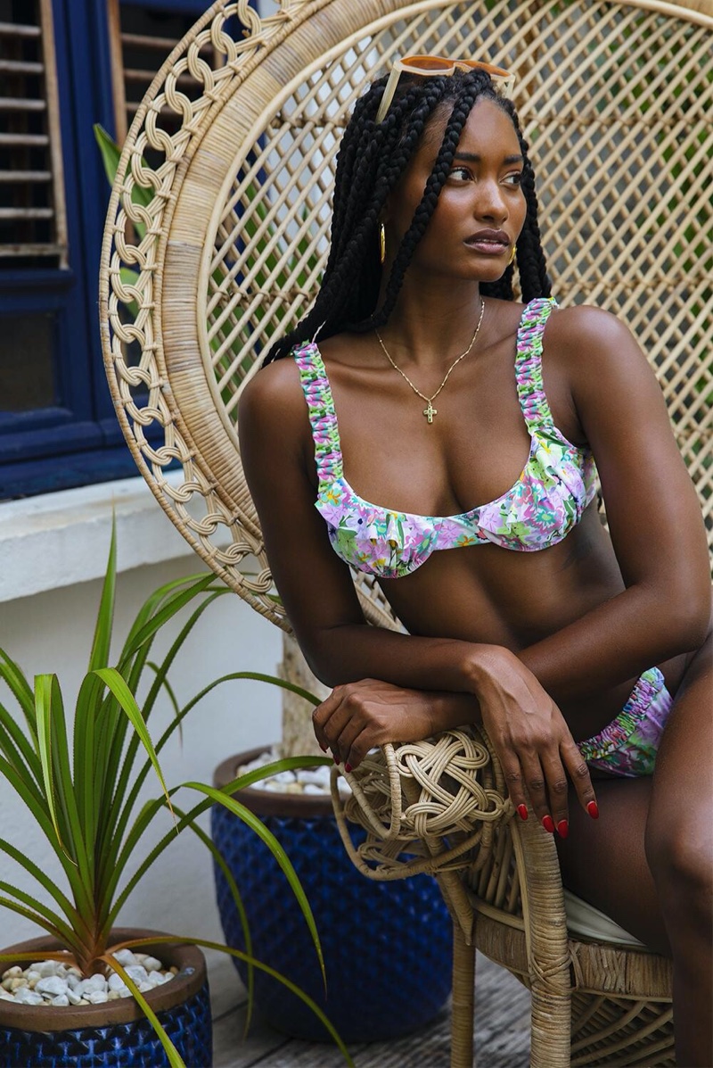 Rocking floral prints, Melodie Monrose poses in For Love & Lemons summer 2020 swimwear.